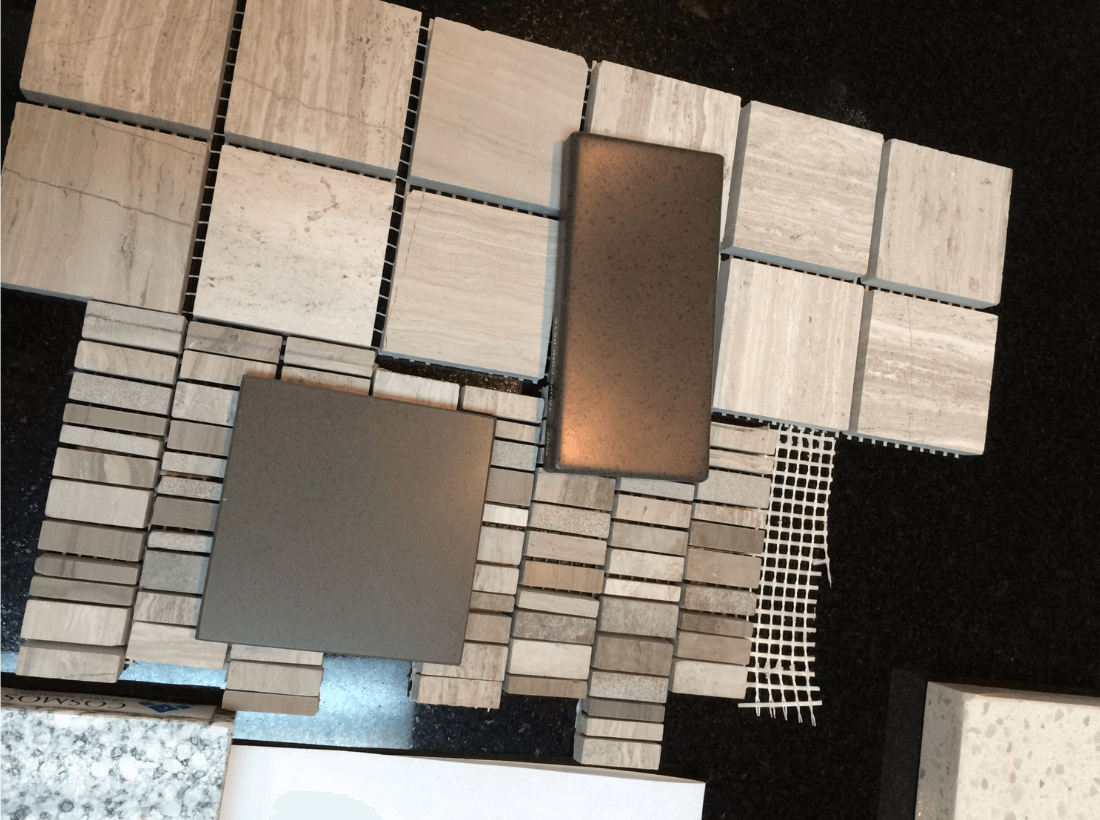 Bathroom tile selection in Cary NC featuring a coordinated board of stone-look tile, mosaic accents, and finish samples. Corner Solutions NC aligns flooring, wall tile, and hardware tones for a unified design.