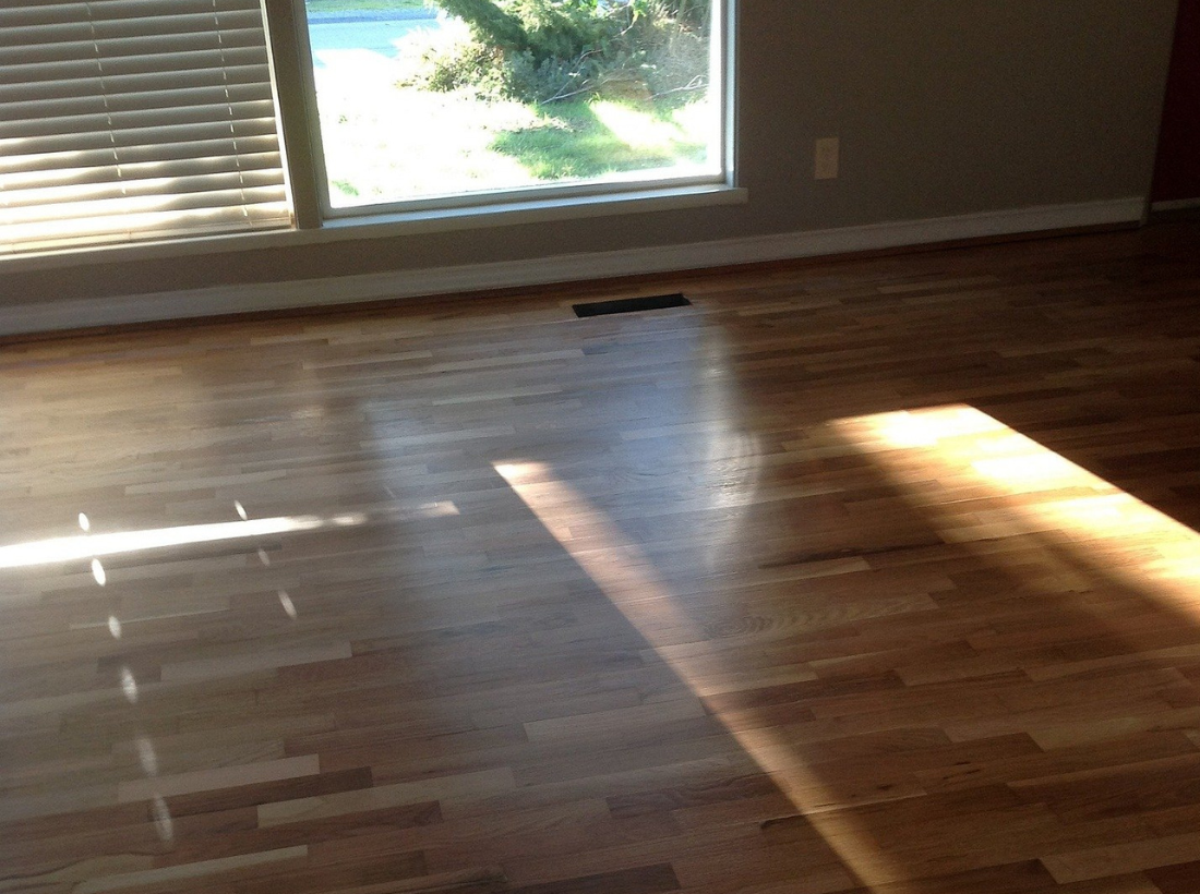 Residential hardwood flooring in Cary NC with a warm natural tone, clean plank variation, and a smooth finished surface. View project details, finish work, and room-ready results.